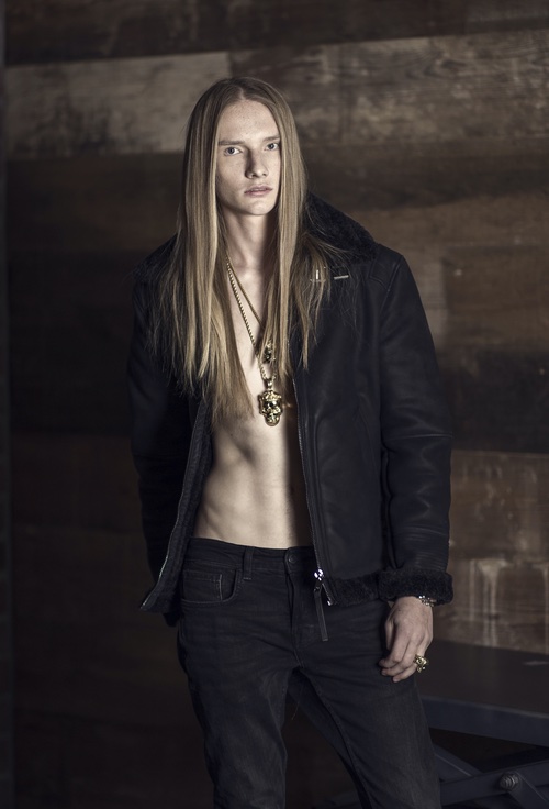 Model in black jacket with gold chains